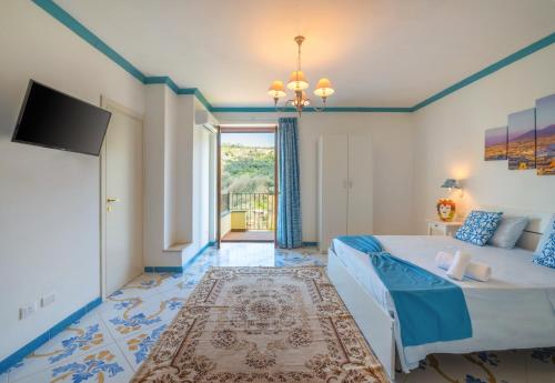 a bedroom with a large bed and a television at Agriturismo Primaluce in Sorrento