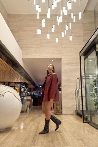 a woman is standing in a store with boots on at Pullman Vina del Mar San Martin in Viña del Mar