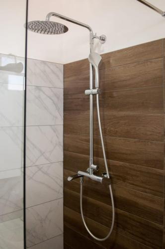 a shower with a shower head in a bathroom at GROTTA in Metković