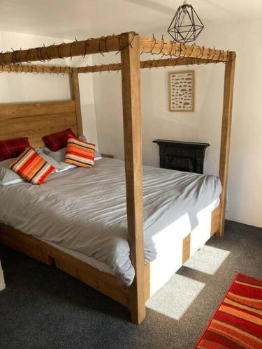 a bedroom with a bed with a wooden bed frame at Leven's Rest in Backbarrow