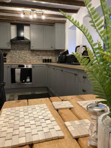 a kitchen with a wooden table and a counter top at Leven's Rest in Backbarrow