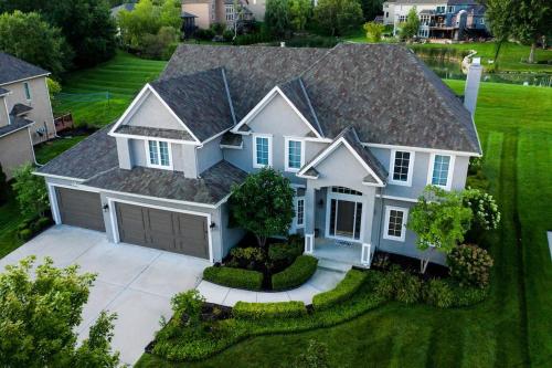 an aerial view of a house with a garage at Beautiful relaxing private villa next to a pond smart home and Traeger Grill in Overland Park