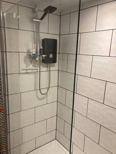 a shower with a soap dispenser in a bathroom at Leven's Rest in Backbarrow