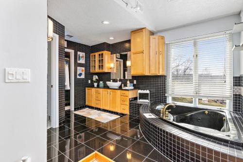 a bathroom with a tub and a sink at Hillside vacation next to Overland Park Kansas nature trail grill and fun in Stilwell