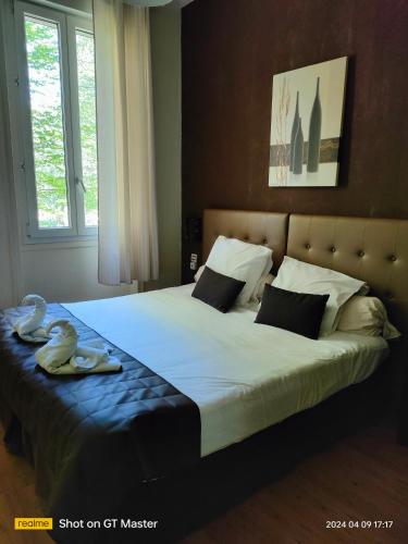 a bedroom with a large bed with two swans on it at Auberge Du Parc in Orgon