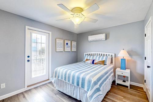 a bedroom with a bed and a ceiling fan at Bogue Banks Beauty - Unit A in Atlantic Beach