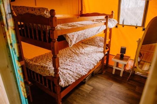 a couple of bunk beds in a room at Rosgarron Safari Canvas Lodge Glorious Glamping in Magherafelt