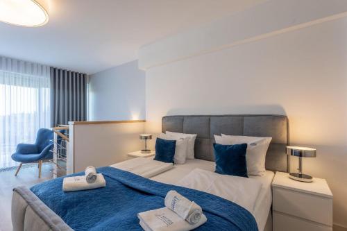een slaapkamer met een groot bed en handdoeken bij Ferienwohnung am Meer, Urlaub auf der Insel Usedom, Apartment Albus 409 in Świnoujście