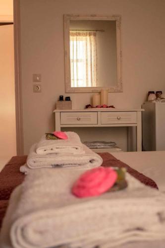 two towels on a bed in a room with a mirror at Kleanthe in Halki