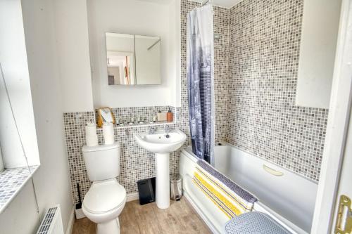 a bathroom with a toilet and a sink at Pass the Keys Well equipped apartment near A46 in Swinderby