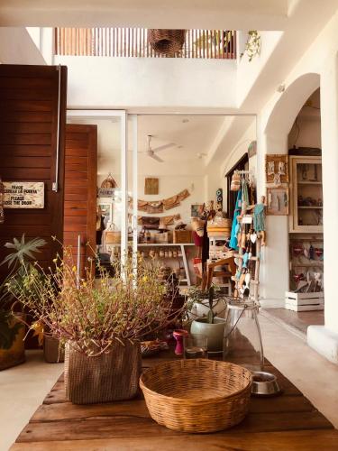 a room with two baskets on a table with plants at Hotel Boutique Pachamama in Mahahual