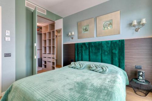 a bedroom with a bed with two towels on it at Prestige Views: Luxury Retreat in Bucharest