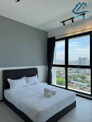 a bedroom with a white bed with a large window at Urban Suites @ George Town Penang by BNB4U in George Town