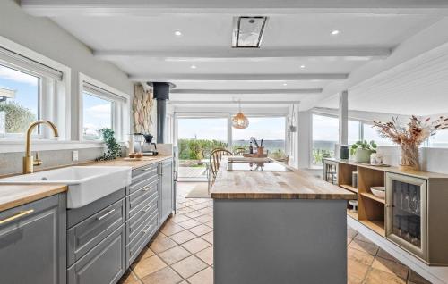 a large kitchen with a sink and a counter at Cozy Home In Esbjerg V With Wifi in Esbjerg