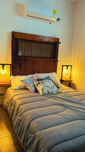 1 dormitorio con 1 cama grande y 2 lámparas en Apartamento Pardo1945 TIPO INDUSTRIAL, en Mompós