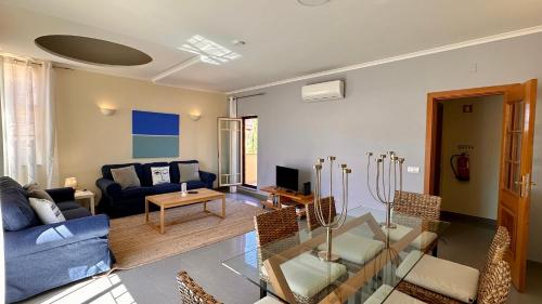a living room with a couch and a table at Bicos 303 - Shared Pool - 6 Guests - Albufeira in Albufeira
