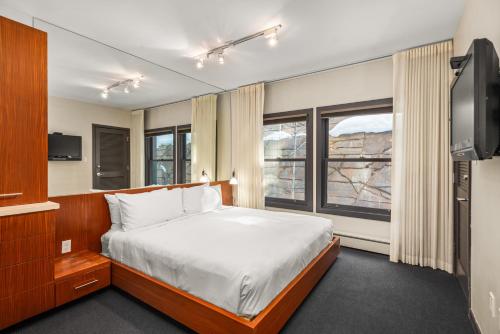 a bedroom with a bed and a tv in it at Durant Unit C2, Condo with Designer Finishes, Great Views & Location in Aspen