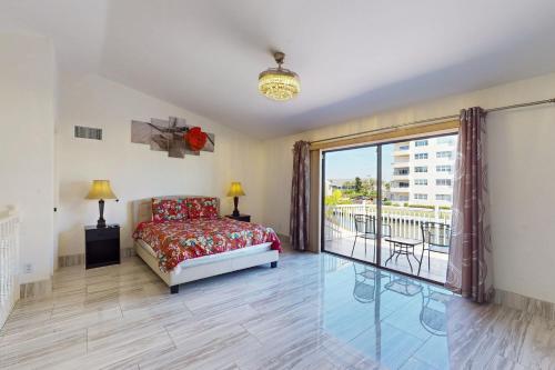 a bedroom with a bed and a balcony at Palms on the Canal in Cape Coral