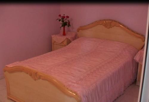 a bedroom with a bed with a vase of flowers at Anna Maria Hotel in Alaverdi