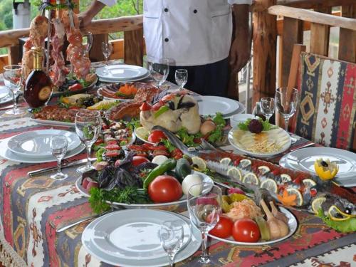a table with plates of food on top of it at Anna Maria Hotel in Alaverdi