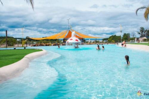 a pool at a theme park with people in the water at Villawolf Casa para 5 personas in Federación
