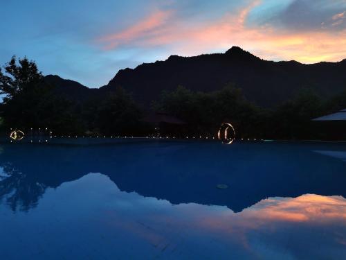 a view of a swimming pool at sunset at Avatar Mountain Resort in Zhangjiajie
