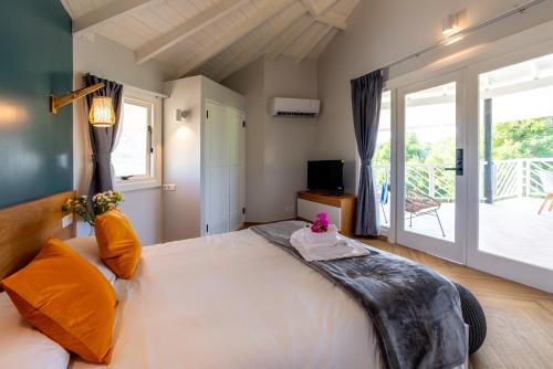 a bedroom with a large bed and a large window at Bed & Bike Westpunt in Westpunt