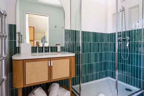 a bathroom with a shower and a sink and a tub at La Villa du Moulleau in Arcachon
