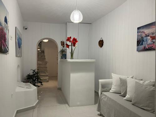 a white living room with a couch and a sink at Villa Pavlina in Karterados