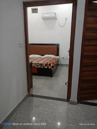a small bedroom with a bed in a room at Radheshyam bhawan in Govardhan