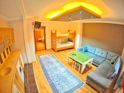 a living room with a couch and a table at Kusva Apart in Uzungol