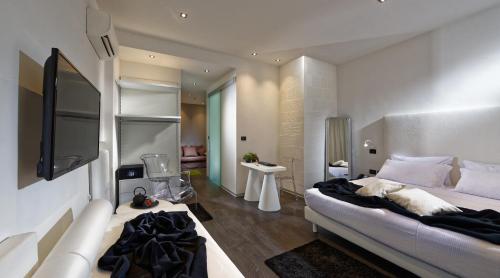 a bedroom with a large bed and a television at Hotel Metropolitan in Bologna