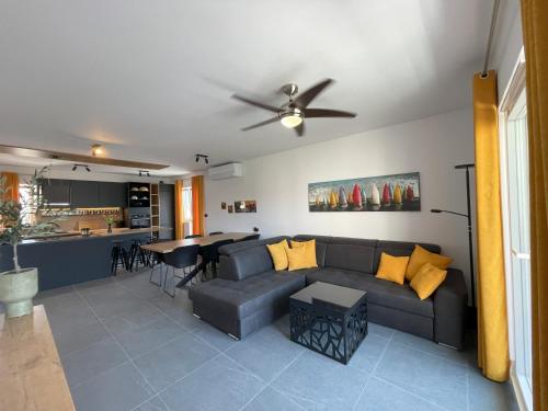 a living room with a couch and a table at Valkane Beach Apartments in Pula