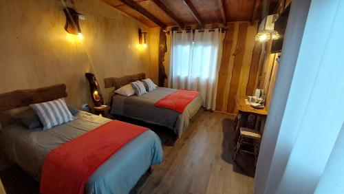 a bedroom with two beds in a room at Cabañas & Habitaciones Del Alto in Hornopiren