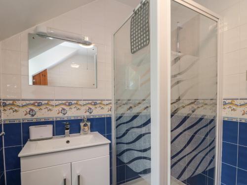 a bathroom with a sink and a shower at Ramblers Cottage in Whitby