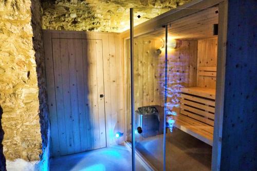 a sauna with a glass shower in a stone wall at Resort Nuvola Srls in Ripabottoni