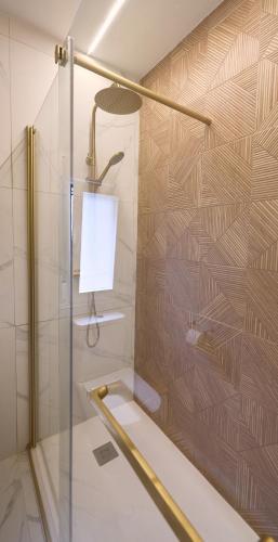 a shower with a glass door and a lamp at Hostal Casa Maria in Batán del Puerto