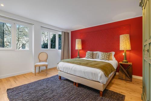 une chambre avec un grand lit avec une tête de lit rouge dans l'établissement Scarlett, à Paris