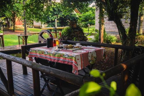 a person sitting at a table with a table cloth at Pousada Equilíbrio dos Canyons in Praia Grande