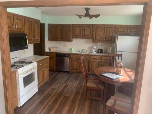 a kitchen with wooden cabinets and a white stove top oven at Whiteshomesplus in Joplin