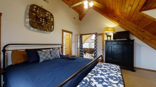 a bedroom with a bed with a blue comforter at Horsin Around Tennessee in Townsend