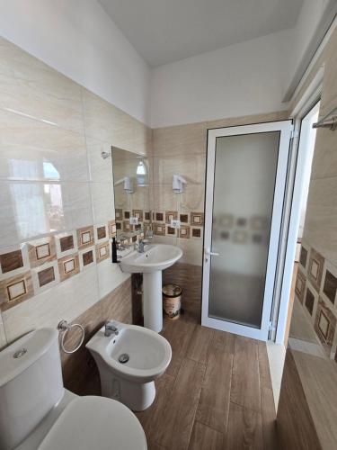 a bathroom with a toilet and a sink and a shower at BLUE AMR in Durrës