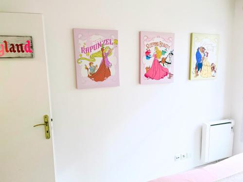 four disney cartoons on a wall in a bedroom at Appartement de Mickey à 5 min de Disneyland Paris in Serris