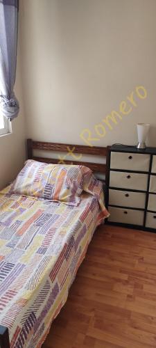 a bedroom with a bed and a dresser at La serena Reinos de España in La Serena