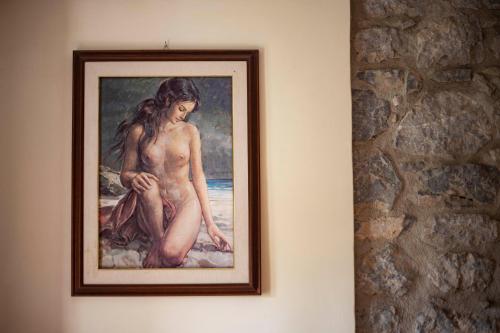 a painting of a naked woman hanging on a wall at Pie' d'Ulivo in Bosco