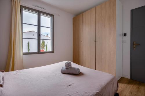 a bedroom with a white bed and a window at Villa avec Jacuzzi et Clim à Marsilly in Lagord
