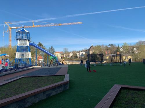 a park with a playground with a roller coaster at Appartement in Misdroy mit Kostenlosem Parkplatz in Międzyzdroje