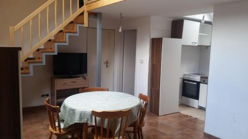 a kitchen and dining room with a table and a staircase at Ferienwohnung für 4 Personen ca 60 qm in Gozd, Krain Innerkrain in Gozd