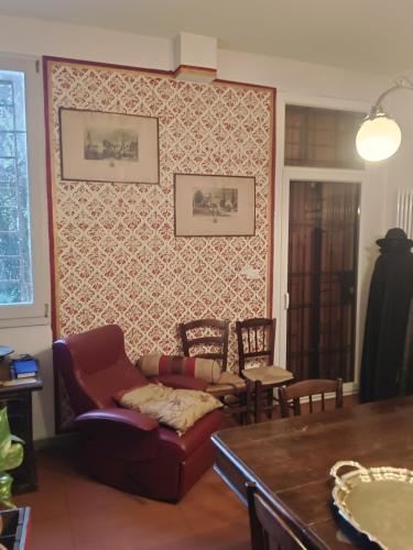 a living room with a couch and chairs and a table at La Maison Rouge in Crespellano