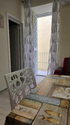a table and two chairs in a room with a window at Scala Paradiso ~ B&B Molfetta in Molfetta